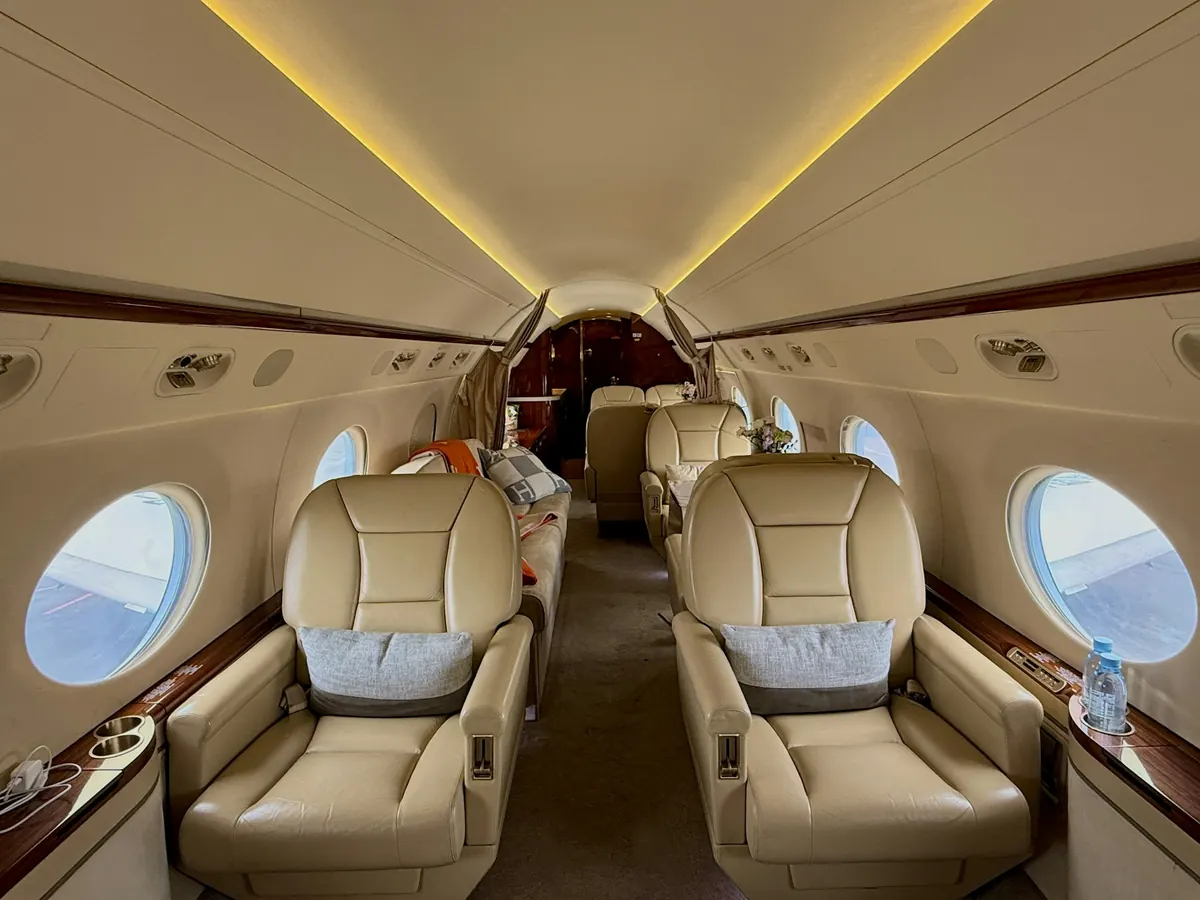 Cream leather seats in a warmly lit private jet cabin